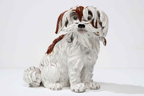 The high art decoration of the apartment. Porcelain dog